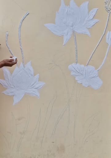 Sculpted Lotus: Lotus flowers and leaves built up in POP relief, shaped by hand before any paint goes on.